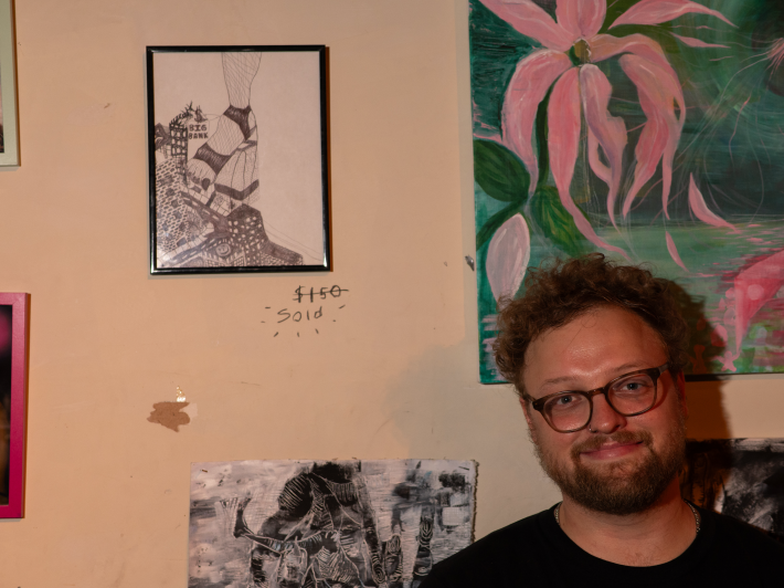 a man next to a piece of art