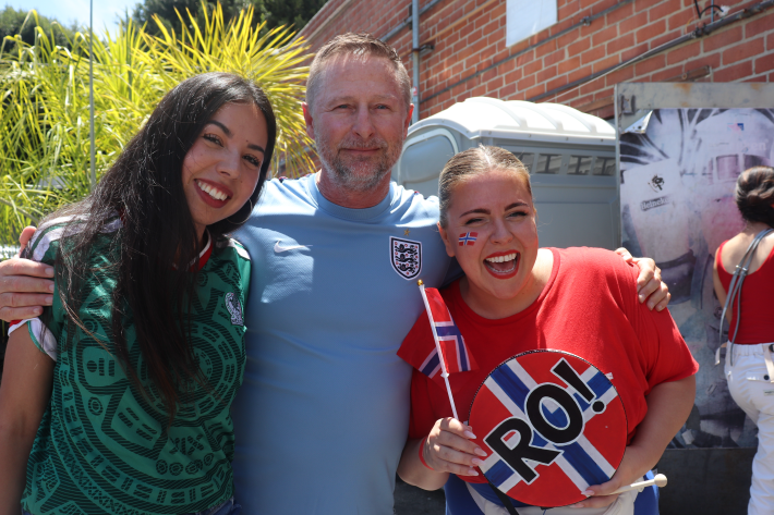 two women and a man pose at a waffle pop-up