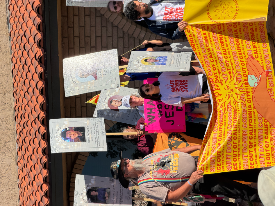protesters with a banner and signs