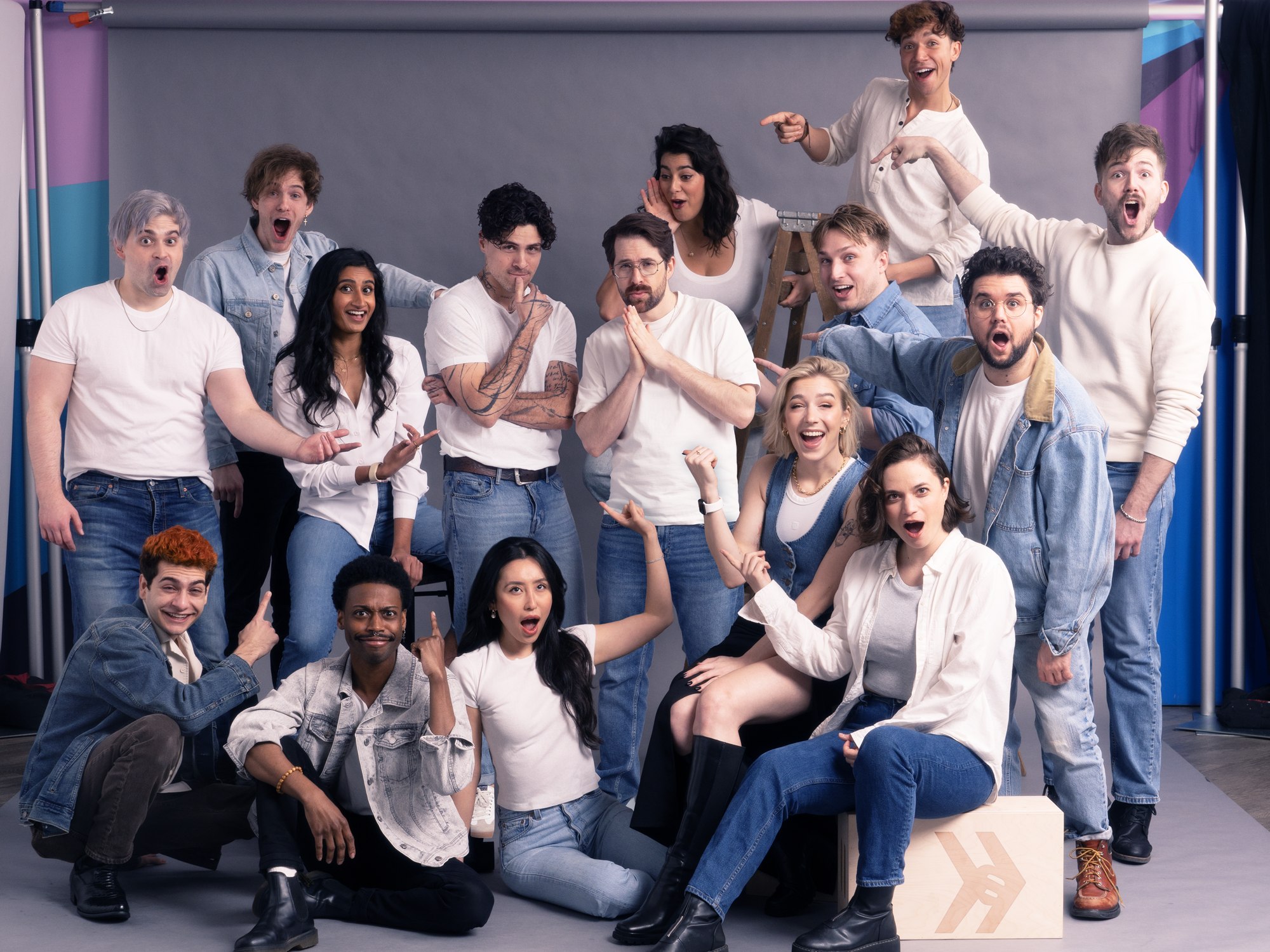 a group of comedians wearing white tops and jeans