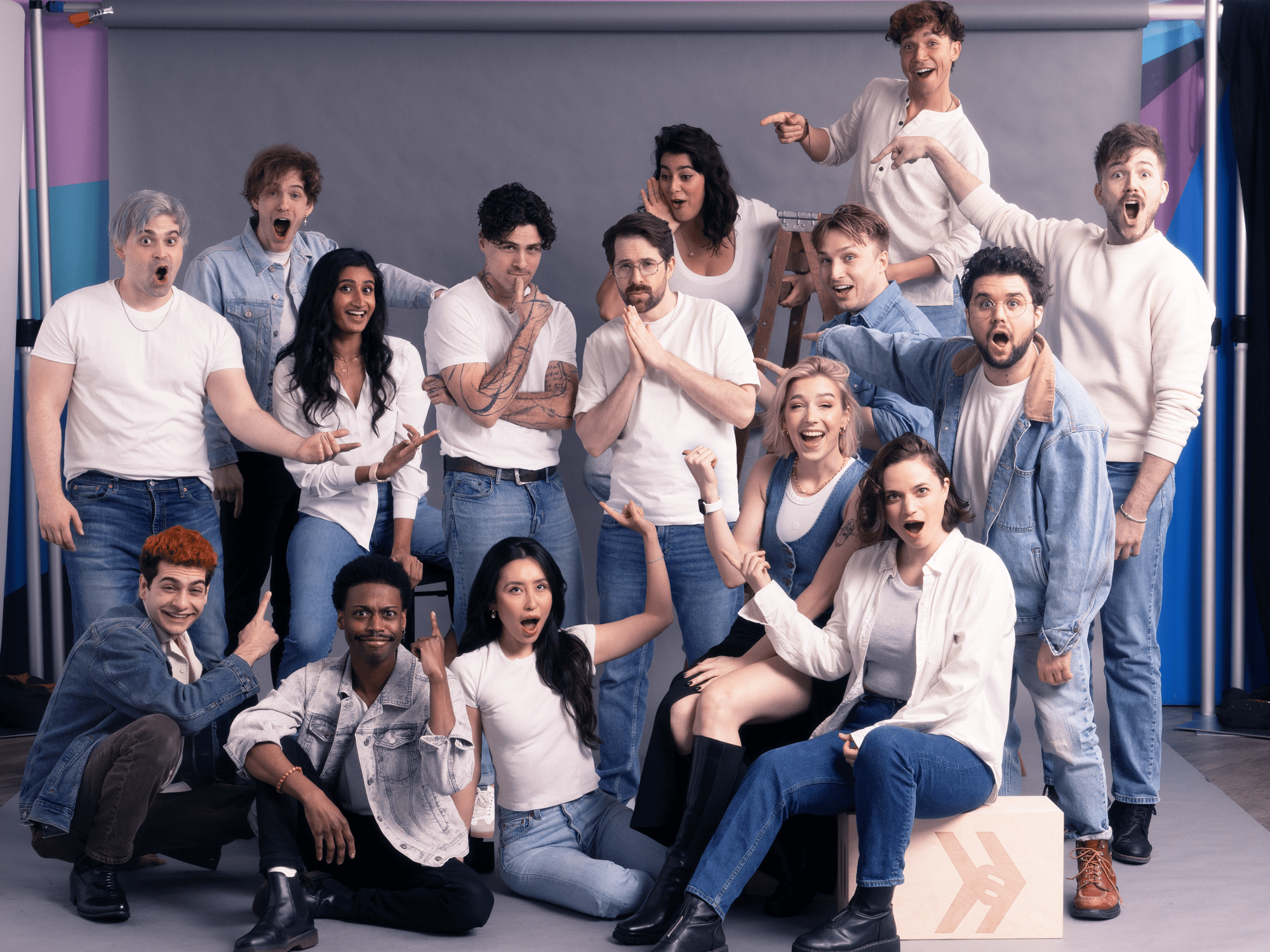 a group of comedians wearing white tops and jeans