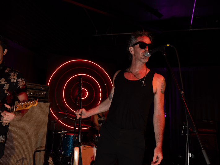 a man in a tank and sunglasses
