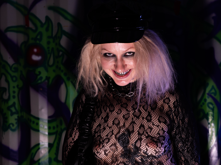 a woman strikes a creepy smile