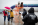 an ICE agent watches as a family boards a plane