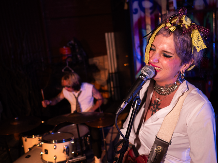 a performer sings into a microphone