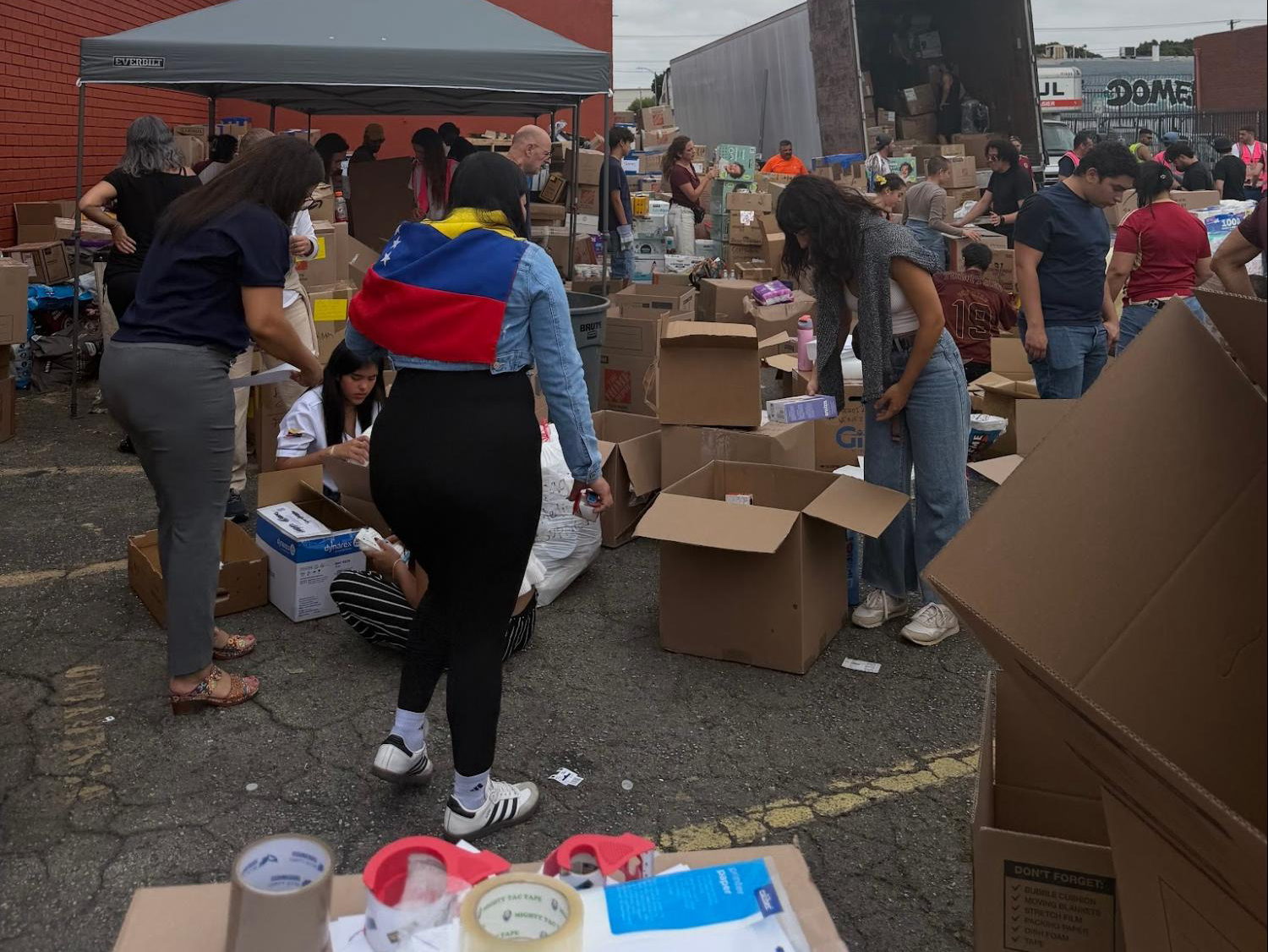 people at a donation center outdoors