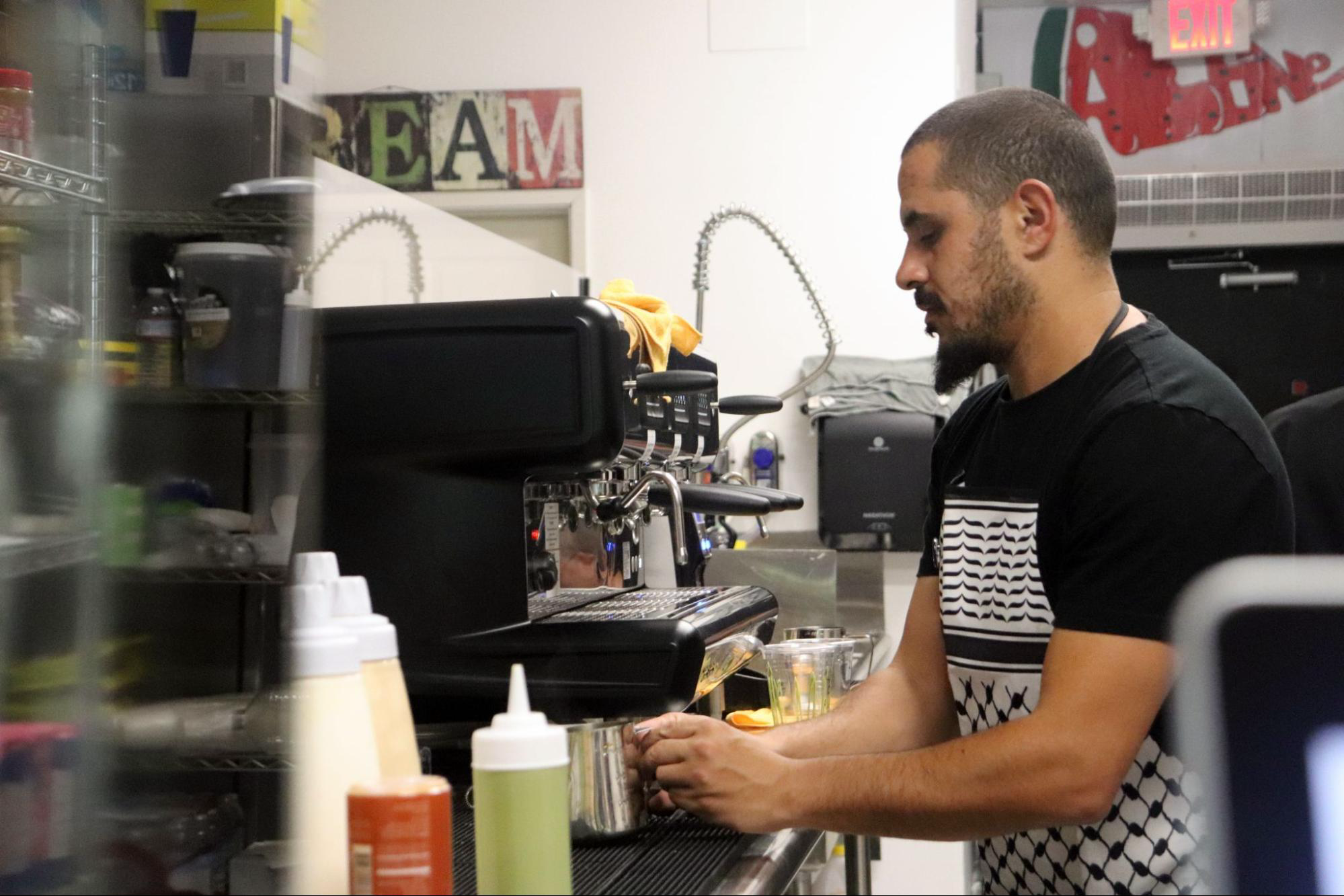 a barista works at the coffee bar