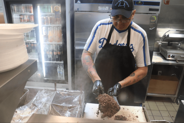 a man cuts into meat