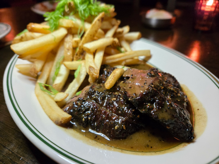 Steak frites on a white plate
