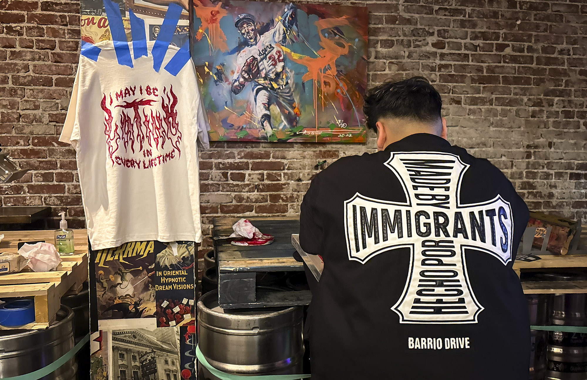 an artist works on screenprinting a shirt