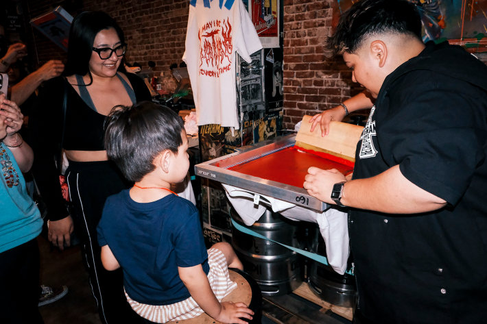 an artist demonstrates the screen-printing process
