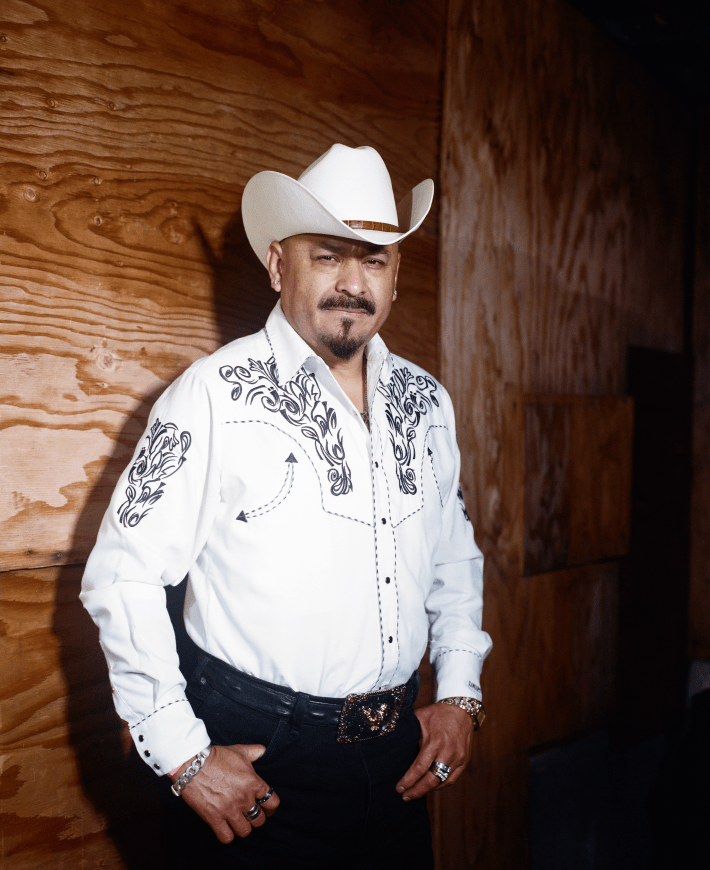 a man with a mustache and cowboy hat