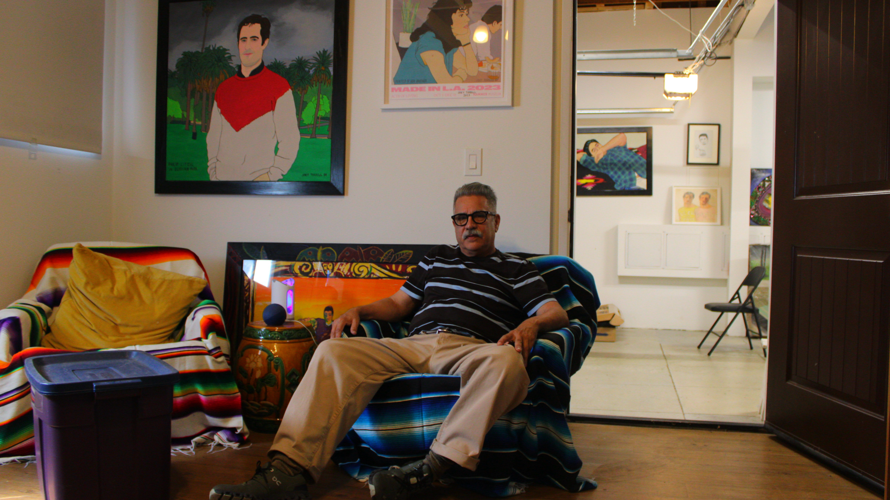 a man sits in his art studio