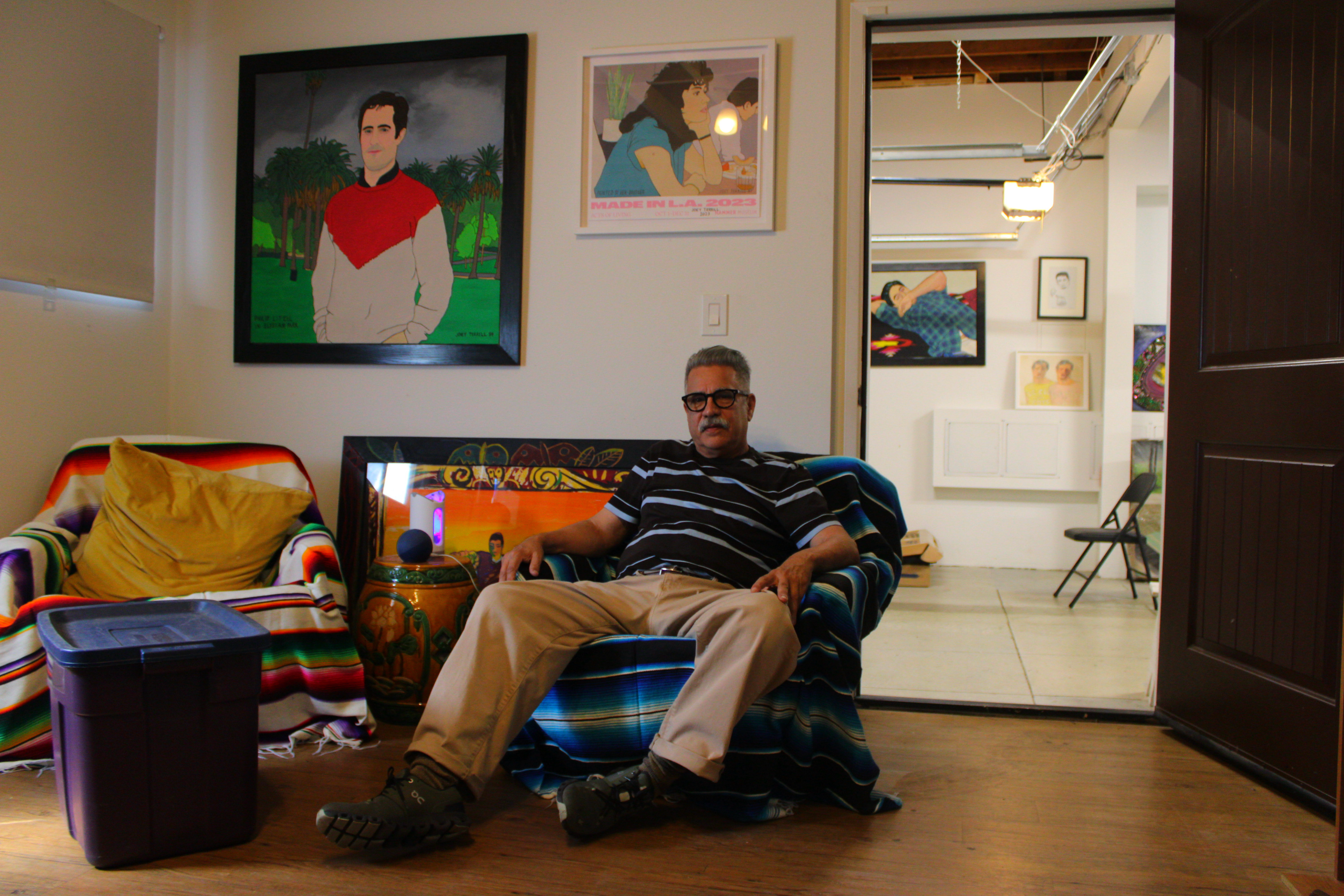 a man sits in his art studio