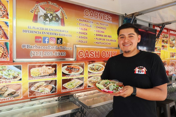 an owner poses outside his food truck