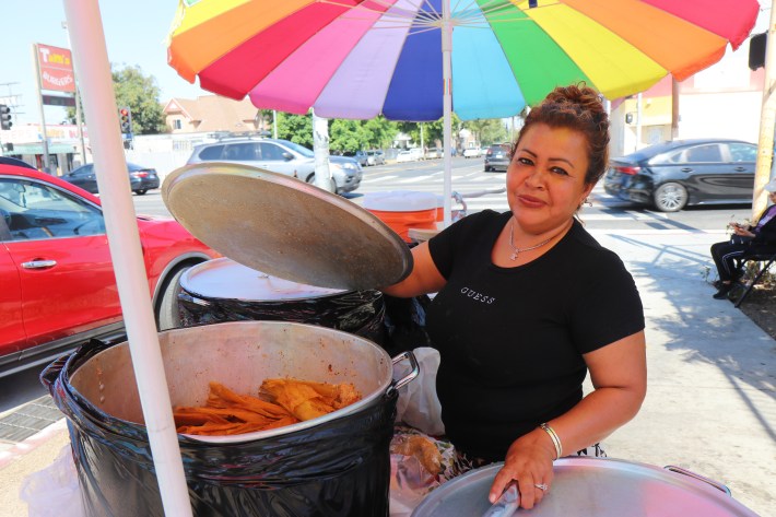 a woman and her tamales stand