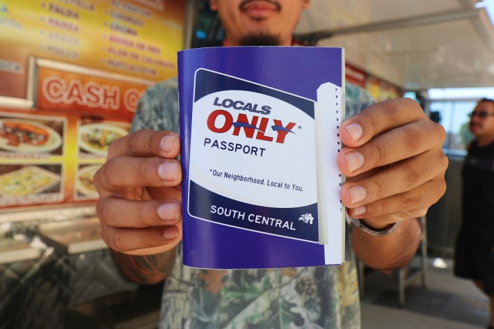 a person holds a passport and coupon booklet