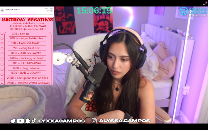 a woman gamer streaming with headphones on