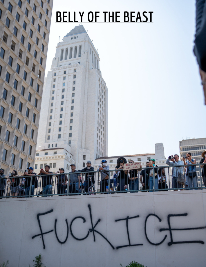Photograph of protesters, photographers, and bystanders in Downtown L.A. above a bridge that says FUCK ICE