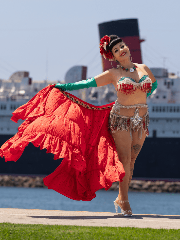a woman poses in front of the Queen Mary