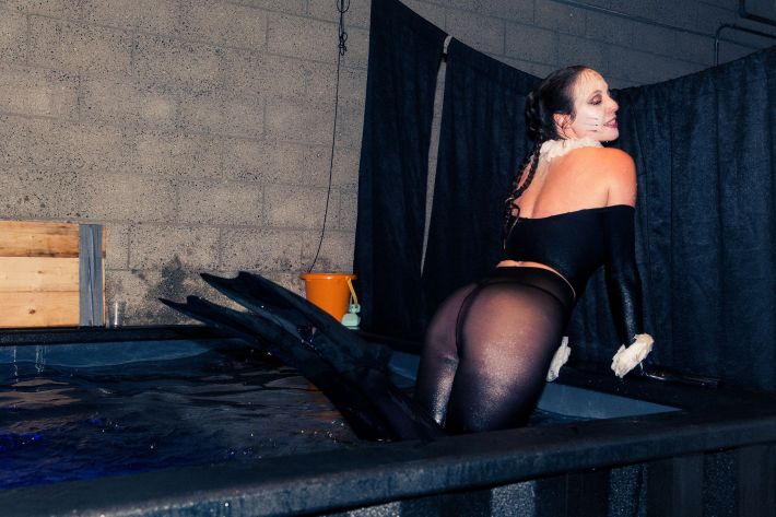 a woman dressed in seal makeup and dark tights