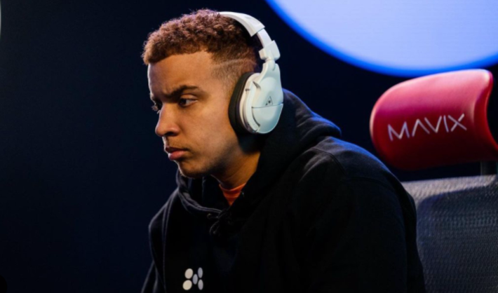 a man with a hoodie and headphones gaming