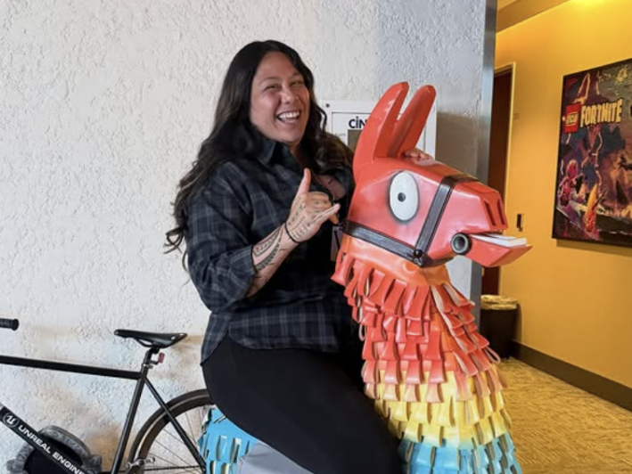 a woman on top of a statue of a Fortnite llama
