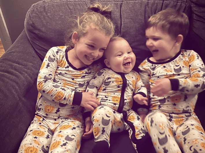 three small children laughing together