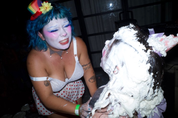 a clown pies another person