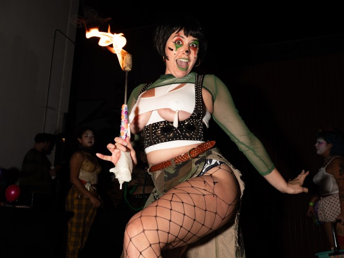 a fire dancer in fishnet