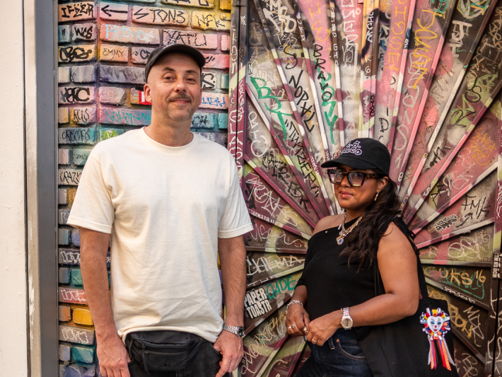 a man and woman next to art