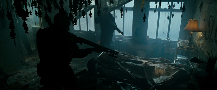 men with guns searching for a man in a building