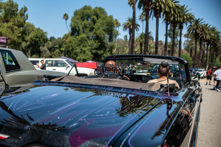 a man drives a classic black car
