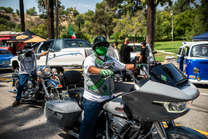 a man in a green bandana on a motorcycle