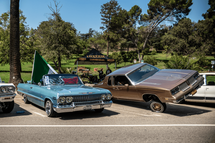 a blue classic car and brown classic car