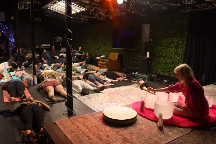 a woman hosting a corporate sound bath event