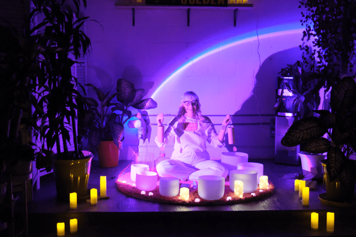 a woman surrounded by sound bowls