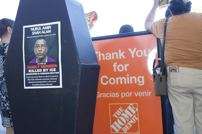 a coffin with the picture of a man who died shortly after being released from ICE custody