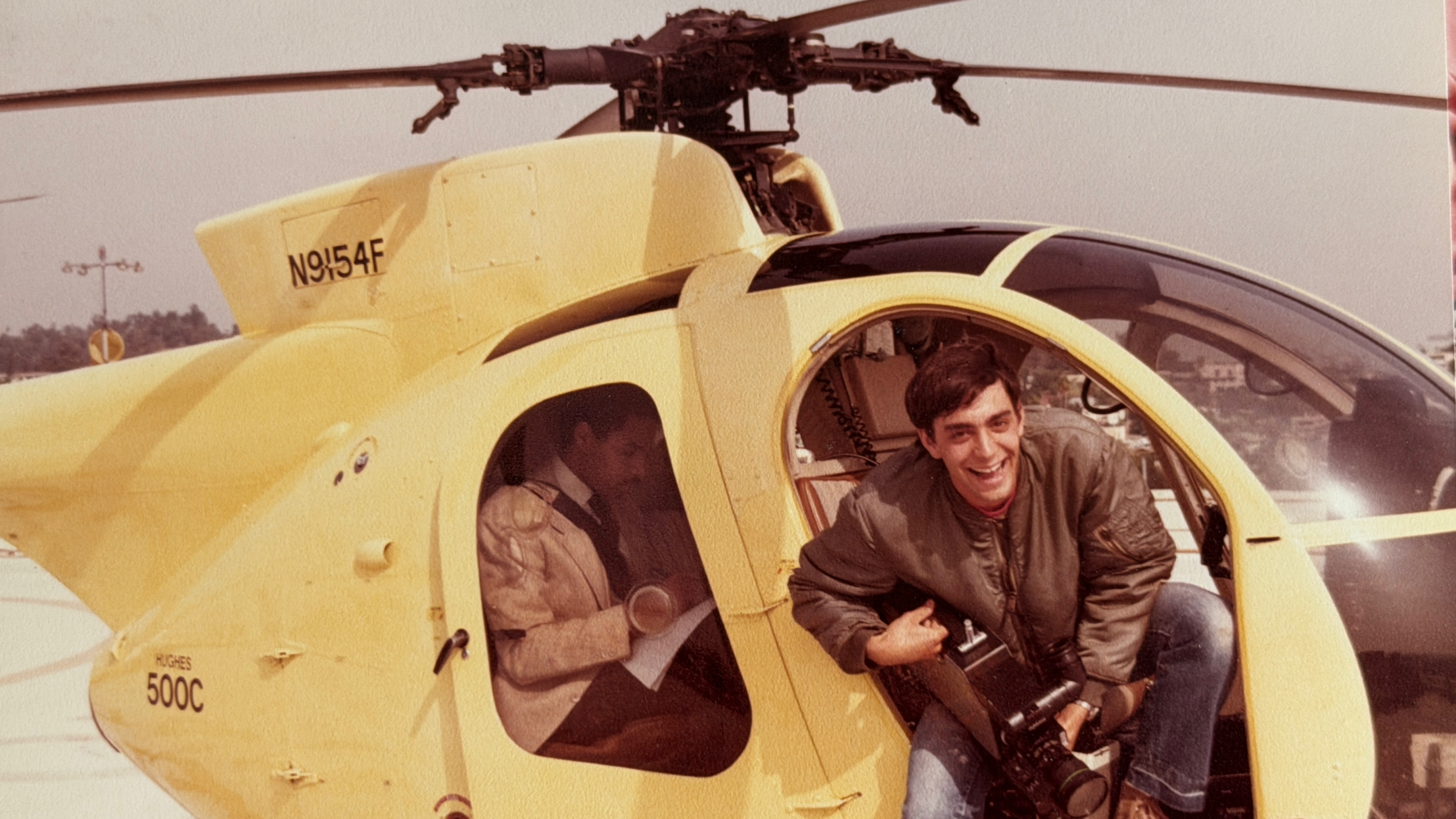 a man holding a camera inside a chopper