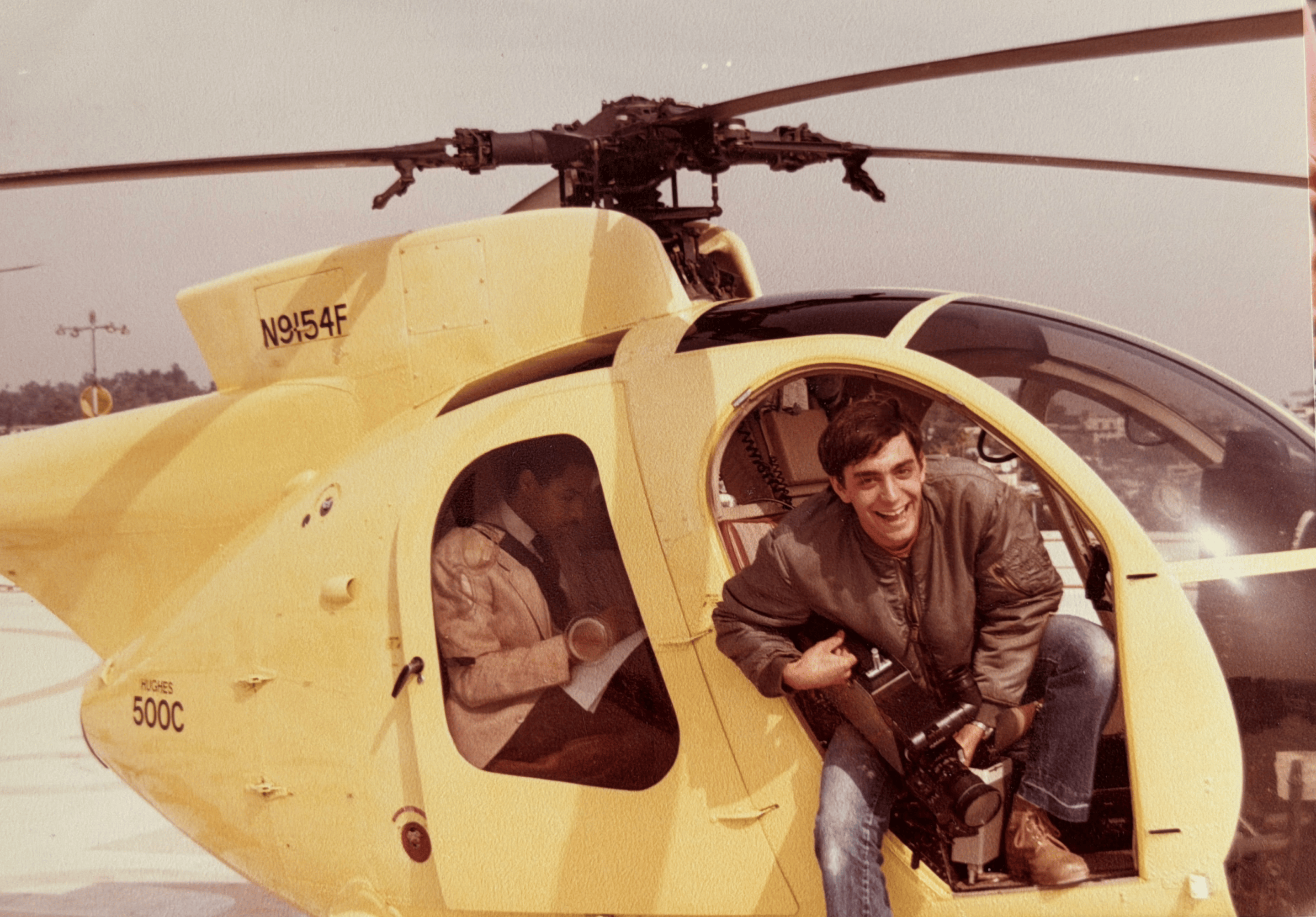 a man holding a camera inside a chopper