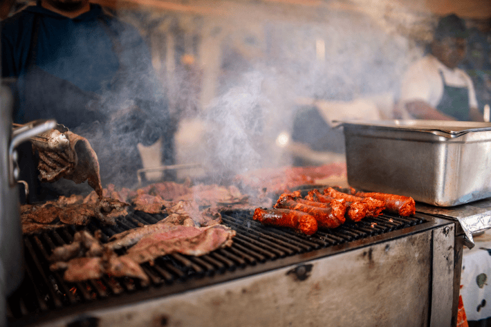steak and chorizo being grilled