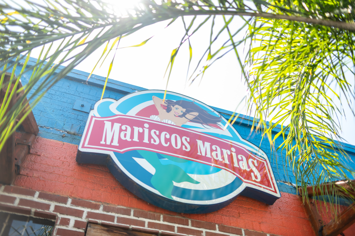 a restaurant sign featuring a mermaid