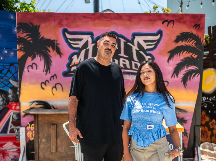 two siblings outside of their restaurant
