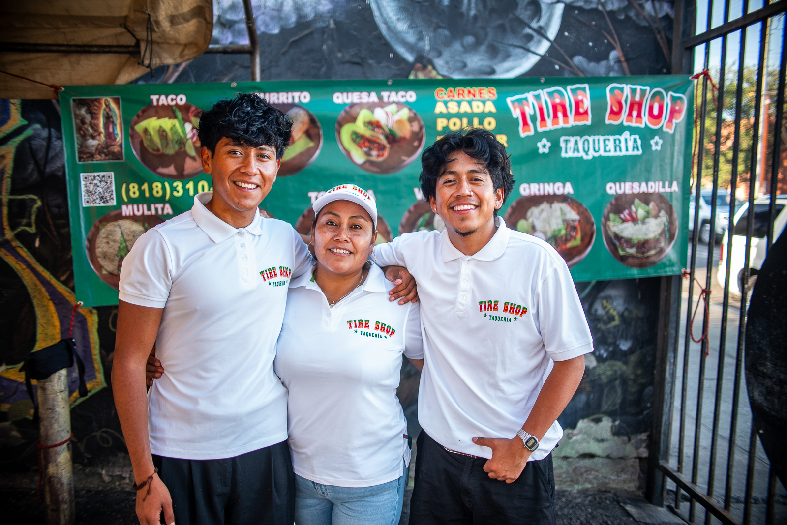two sons and their mom outside of their family's taco shop