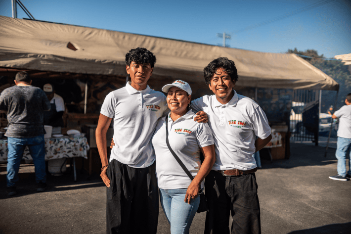 two sons and their mom outside of their family's taco shop