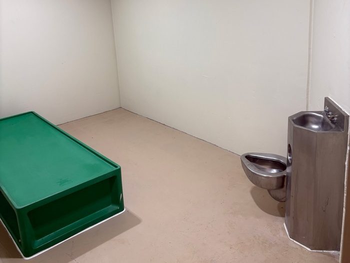a small cell with a bed and toilet and sink