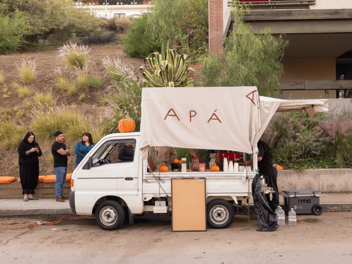 a coffee truck with a line forming