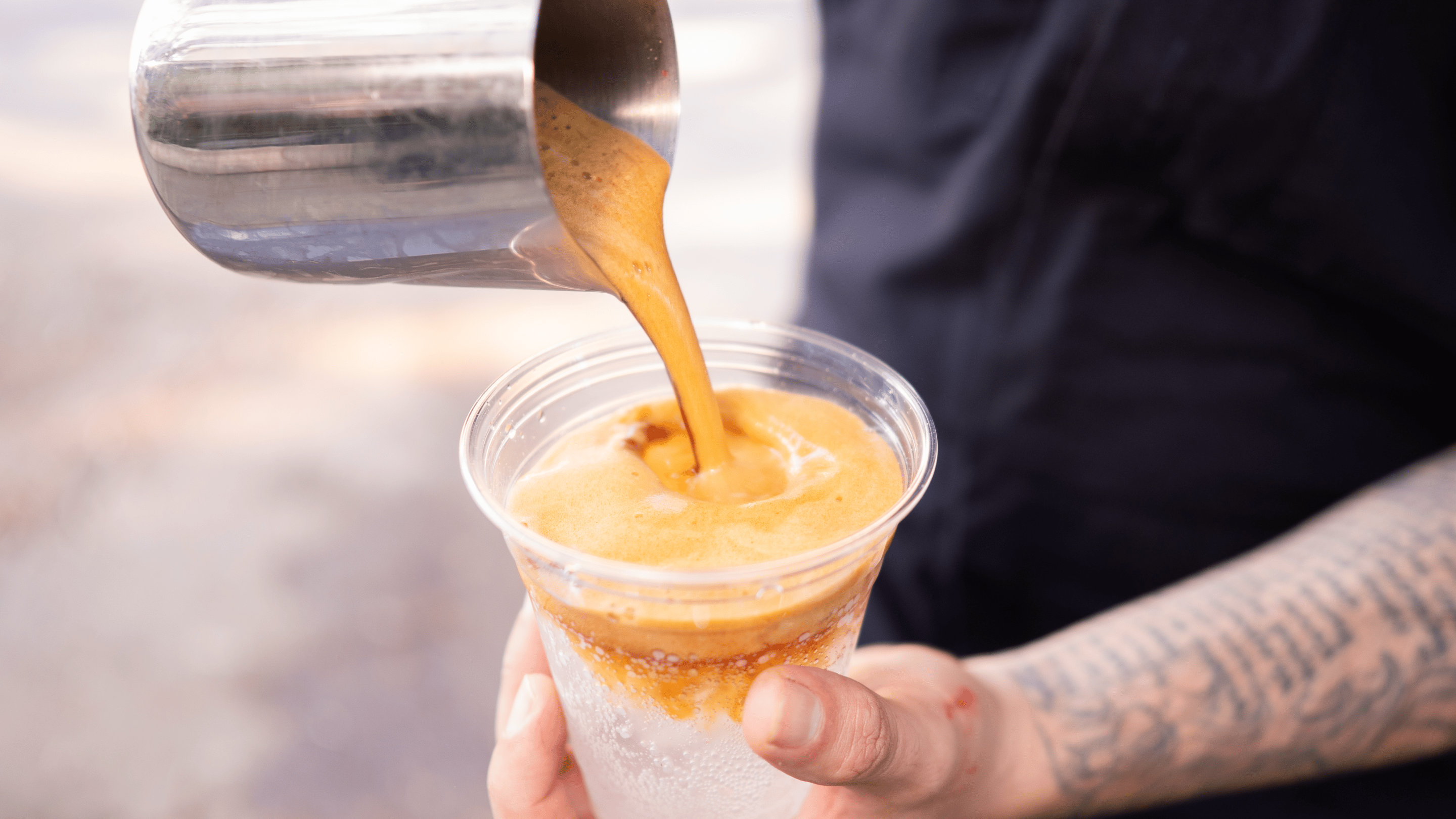 a man pours a latte