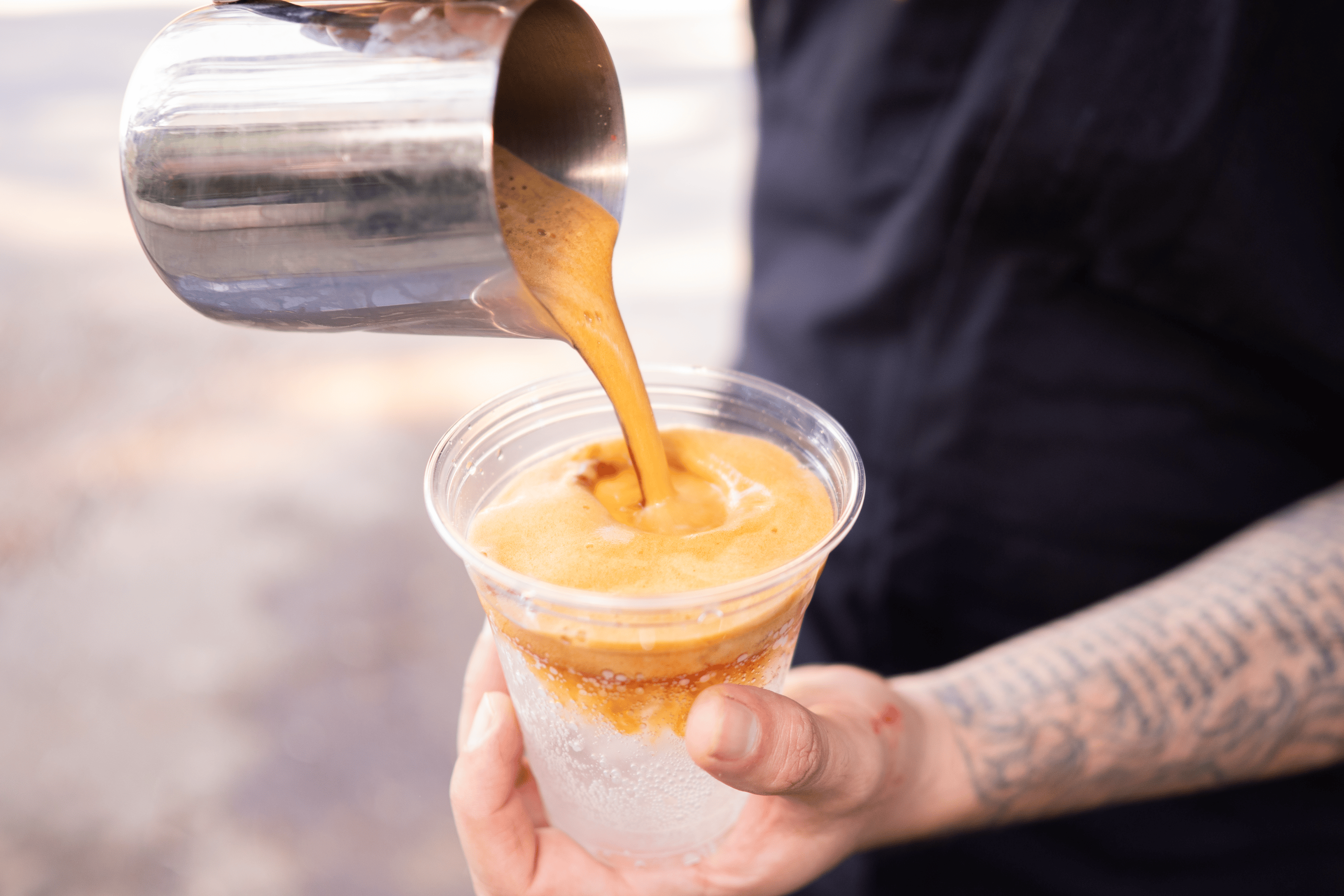 a man pours a latte