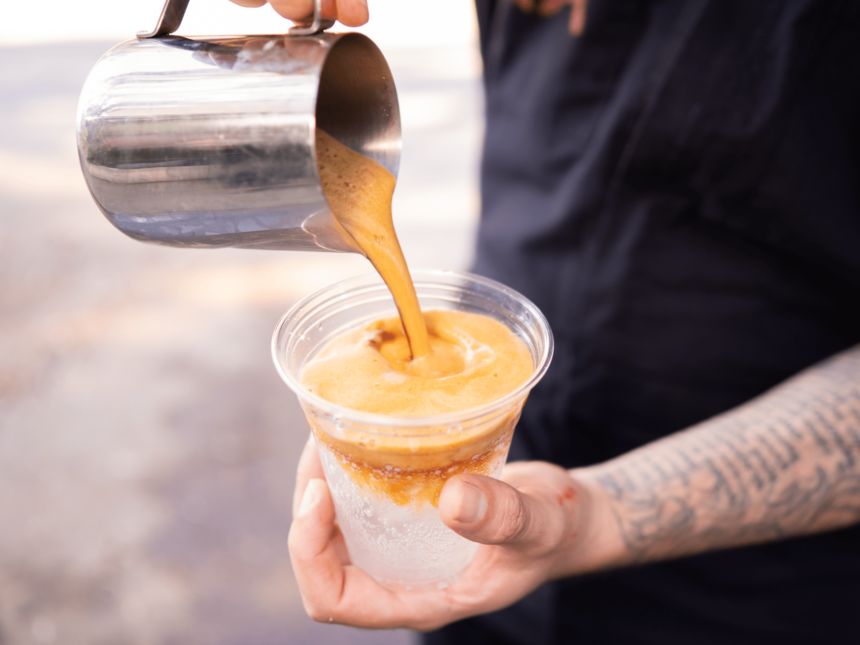 a man pours a latte